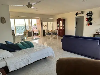 a bedroom with a bed and a living room at Beach, kitesurfing loft en Cartagena, La Boquilla in Cartagena de Indias