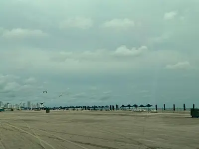 a kite flying in the sky over a beach at Beach, kitesurfing loft en Cartagena, La Boquilla in Cartagena de Indias