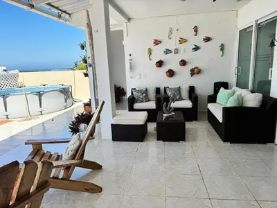 a living room with a couch and a chair at Beach, kitesurfing loft en Cartagena, La Boquilla in Cartagena de Indias