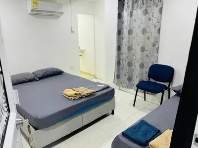 a bedroom with a bed and a chair in it at Habitación cerca a la playa 105 in Cartagena de Indias