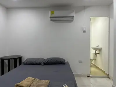 a bedroom with a bed and a sink in a room at Habitación cerca a la playa 105 in Cartagena de Indias