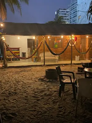 a hammock in front of a house at night at Home Beach Kristalu in Cartagena de Indias