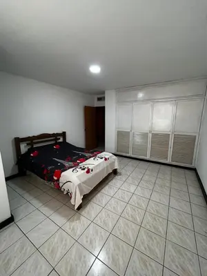 a bedroom with a bed and a tiled floor at Hostal Tayrona in Santa Marta