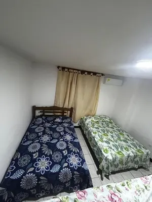 a bedroom with two beds in a room at Hostal Tayrona in Santa Marta