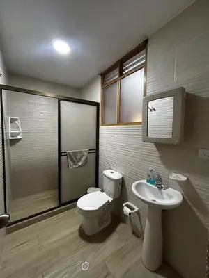 a bathroom with a toilet and a sink at Hostal Tayrona in Santa Marta
