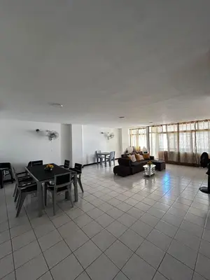 a living room with a table and a couch at Hostal Tayrona in Santa Marta