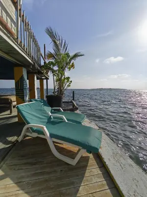 two lounge chairs sitting on a dock next to the water at Casa Acuarimantima in Tintipan Island