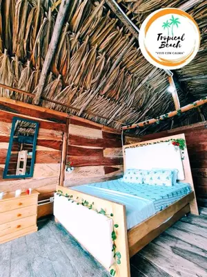a bedroom with a bed in a straw hut at Tropical Beach in Playa Blanca