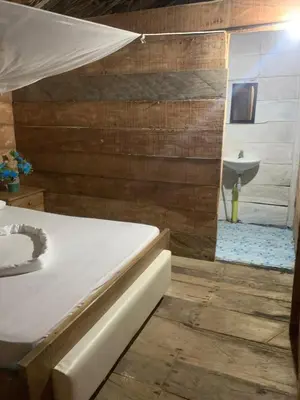 a bedroom with a bed and a bathroom with a sink at Tropical Beach in Playa Blanca