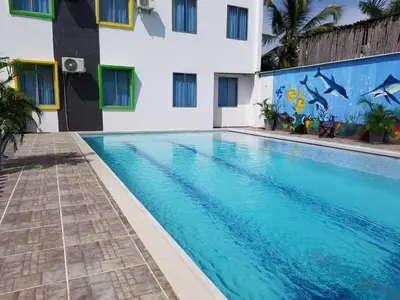 a swimming pool in front of a building at Apartamento con piscina in San Silvestre