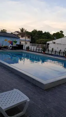 a large swimming pool with a chair in front of a building at Apartamento con piscina in San Silvestre