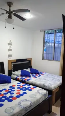 two beds sitting next to each other in a bedroom at Apartamento con piscina in San Silvestre