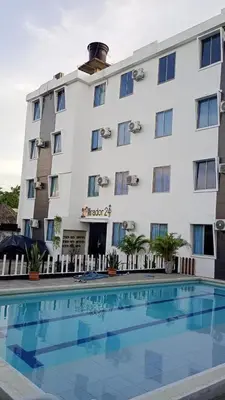 a hotel with a swimming pool in front of a building at Apartamento con piscina in San Silvestre