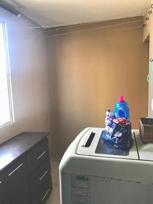 a kitchen with a washing machine with a blue bottle on it at Apartamento Carnavalero calle 72, ubicación privilegiada eventos de carnaval zona norte in Barranquilla