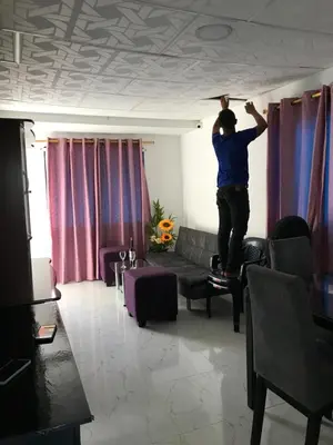 a man standing on a ceiling in a living room at La Armonia in Cartagena de Indias