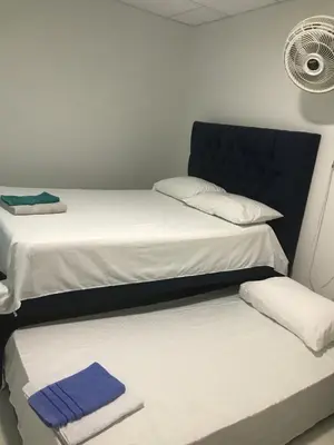 two beds in a room with towels on them at La Armonia in Cartagena de Indias