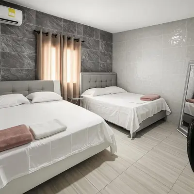 a bedroom with two beds in a room at Casa con piscina cerca al aeropuerto in Malambo