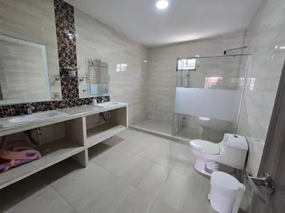 a bathroom with a toilet and a sink and a shower at Casa con piscina cerca al aeropuerto in Malambo