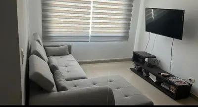 a living room with a couch and a flat screen tv at Barranquilla Carnival 4 PX in Barranquilla