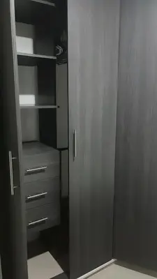 a walk in closet with wooden doors and drawers at Barranquilla Carnival 4 PX in Barranquilla