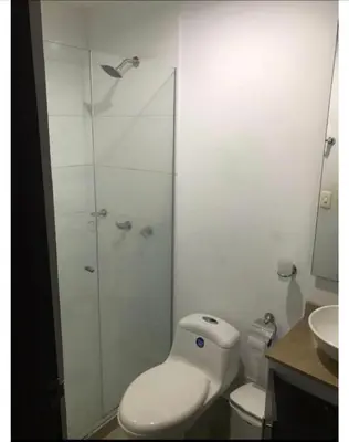 a bathroom with a toilet and a glass shower at Barranquilla Carnival 4 PX in Barranquilla