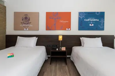two beds sitting next to each other in a room at Pop Art Hotel CLC Puerto Mamonal Cartagena in Cartagena de Indias