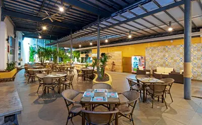 a restaurant with tables and chairs in a room at Pop Art Hotel CLC Puerto Mamonal Cartagena in Cartagena de Indias