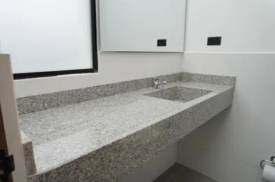 a bathroom counter with a sink and a mirror at Hotel INdustrial in Sincelejo