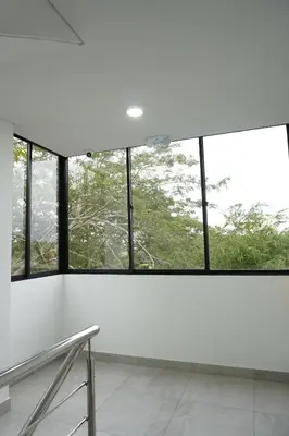 an empty room with windows and white walls at Hotel INdustrial in Sincelejo