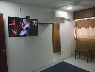a tv hanging on a wall in a room at Apartamento al norte de Barranquilla in Barranquilla
