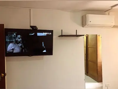 a flat screen tv hanging on a wall at Apartamento al norte de Barranquilla in Barranquilla