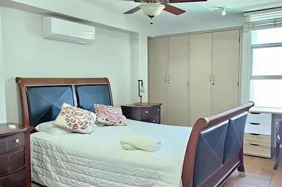 a bedroom with a bed and a ceiling fan at Casa de playa privada Sabanilla 4 cuadras del mar in Maizal