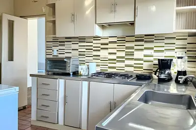 a kitchen with white cabinets and a sink at Casa de playa privada Sabanilla 4 cuadras del mar in Maizal