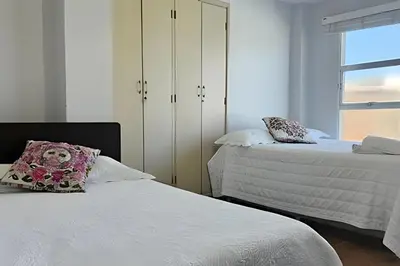a bedroom with two beds and a window at Casa de playa privada Sabanilla 4 cuadras del mar in Maizal