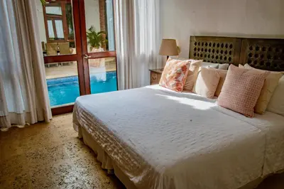 a bedroom with a bed and a large window at 5 BR Villa inside of the walled city in Cartagena de Indias
