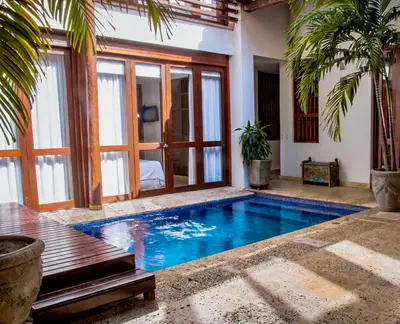 a swimming pool in the middle of a house at 5 BR Villa inside of the walled city in Cartagena de Indias