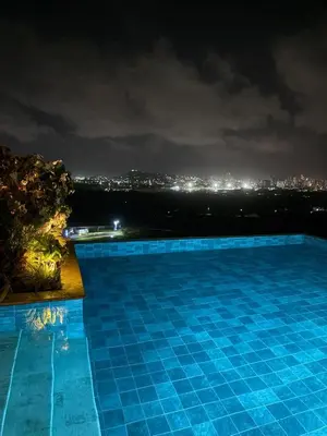a swimming pool at night with a city skyline at Como estar en casa! in Cartagena de Indias