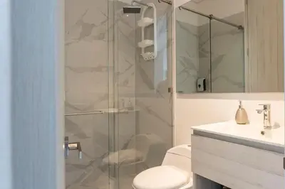 a bathroom with a shower with a toilet and a sink at Apto de Lujo con Vista al Mar en Playa Bello Horizonte in Santa Marta