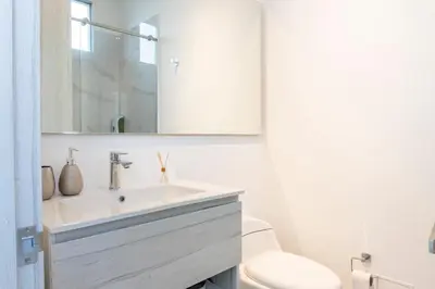 a bathroom with a sink and a toilet and a mirror at Apto de Lujo con Vista al Mar en Playa Bello Horizonte in Santa Marta