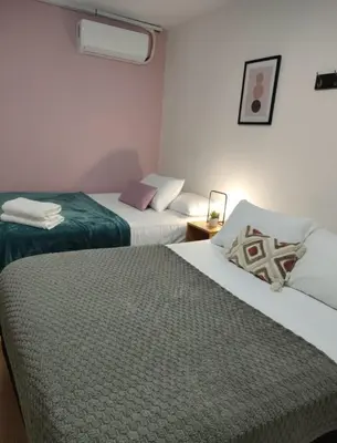 a hotel room with two beds and a table at Casa Plenitud Lux in Cartagena de Indias