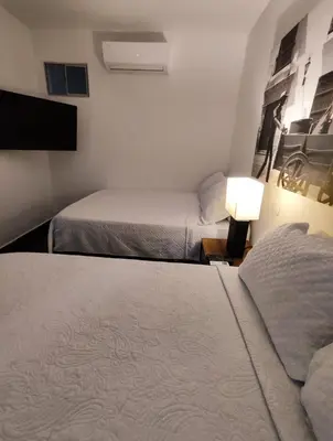 a hotel room with two beds and a tv at Apartamento en cartagena - cristoforo piso 7 in Cartagena de Indias