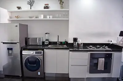 a kitchen with a stove and a washing machine at Apartamento en cartagena - cristoforo piso 7 in Cartagena de Indias