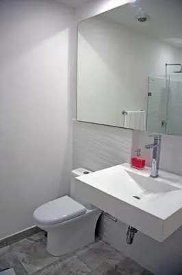 a bathroom with a sink and a toilet and a mirror at Apartamento en cartagena - cristoforo piso 7 in Cartagena de Indias