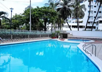 a swimming pool with blue water in a building at Apartamento en cartagena - cristoforo piso 7 in Cartagena de Indias