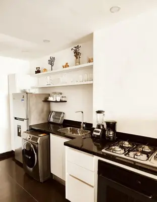 a kitchen with a stove top oven next to a sink at Apartamento en cartagena - cristoforo piso 7 in Cartagena de Indias