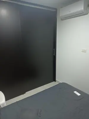 a sliding glass door in a room with a bed at Alquiler Apartamento Amoblado in Barranquilla