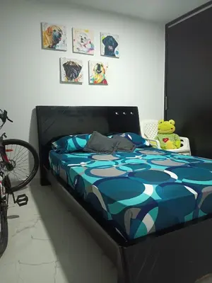 a bedroom with a bed with a teddy bear on it at Alquiler Apartamento Amoblado in Barranquilla