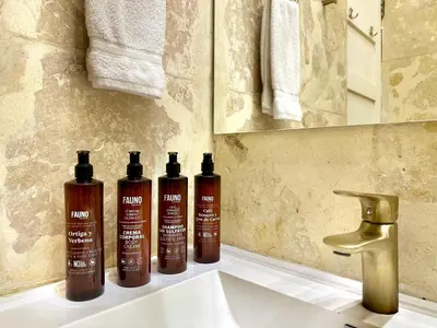 three bottles of shampoo sitting on a bathroom sink at by Calamari Homes - El Porvenir 206 walled city in Cartagena de Indias