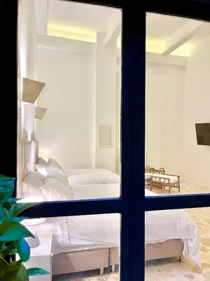 a bedroom with a view of a bed through a window at by Calamari Homes - El Porvenir 206 walled city in Cartagena de Indias