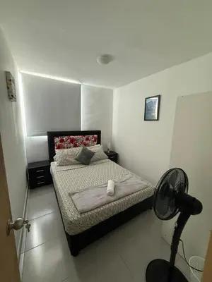 a bedroom with a bed and a fan in it at Beautiful Ocean view apartment in Cartagena de Indias
